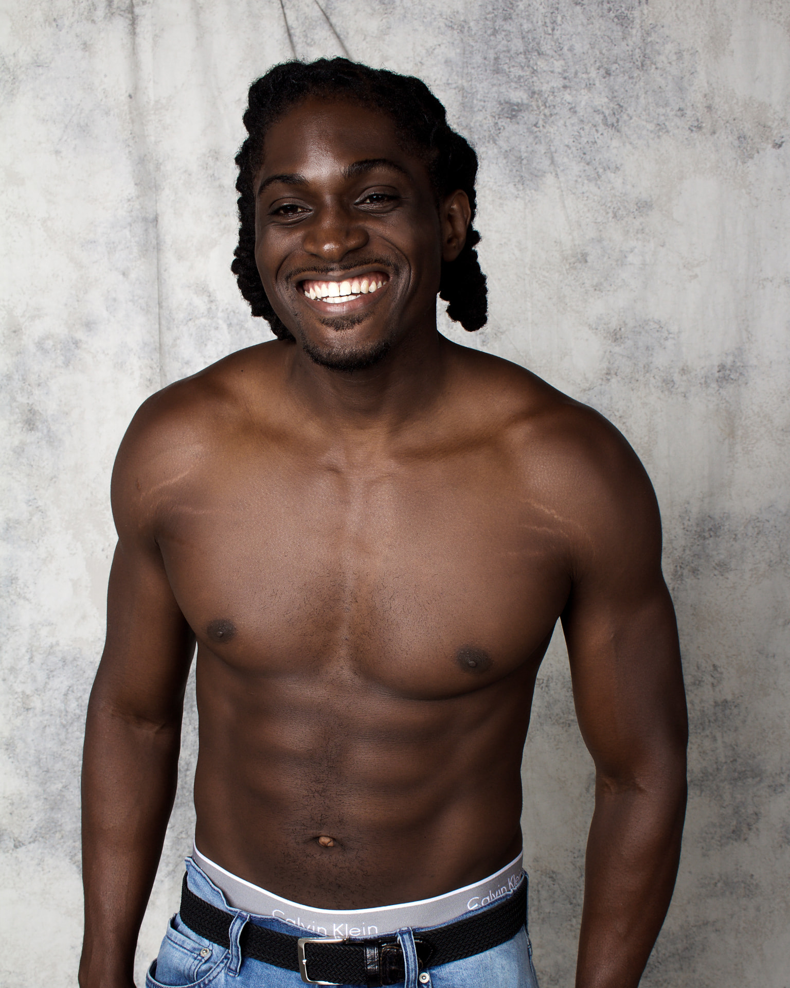 Godwin smiling in a studio portrait